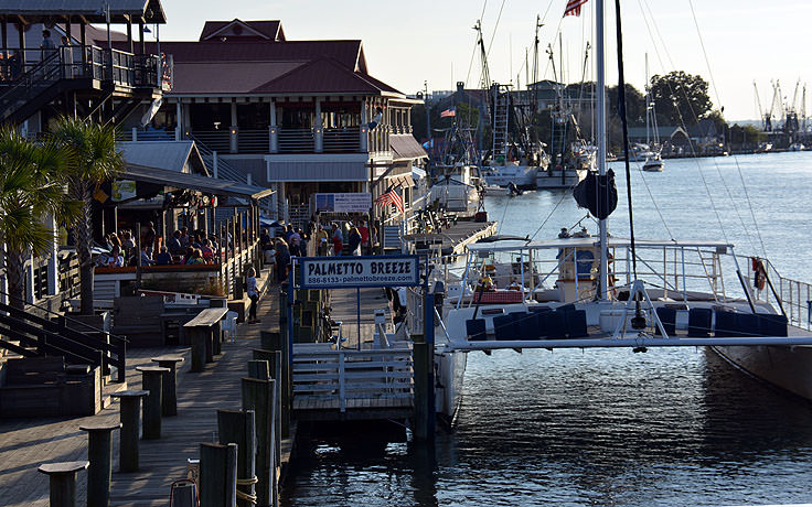 Boats and restaurants line Shem Creek in Mt. Pleasant, SC