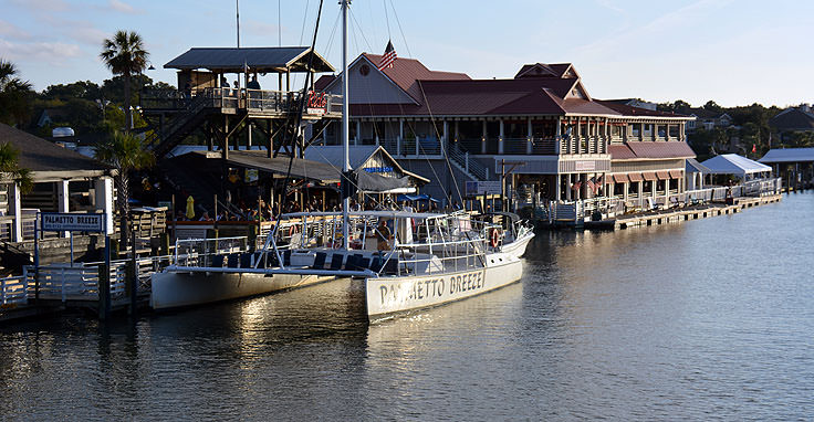 Boats and restaurants line Shem Creek in Mt. Pleasant, SC